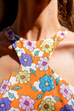 Orange 1960's style mini dress with multi-color floral print. Print by Dave Hill.