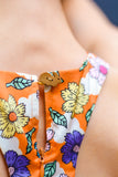 Orange 1960's style mini dress with multi-color floral print. Print by Dave Hill.