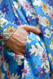 1960's style shirt dress. Mary Quant inspired bright blue dress with multi-color floral print. Print by Dave Hill.