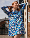 1960's style shirt dress. Mary Quant inspired bright blue dress with multi-color floral print. Print by Dave Hill.