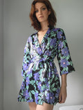 Women's black robe with purple flower print all over.  Print by Dave Hill